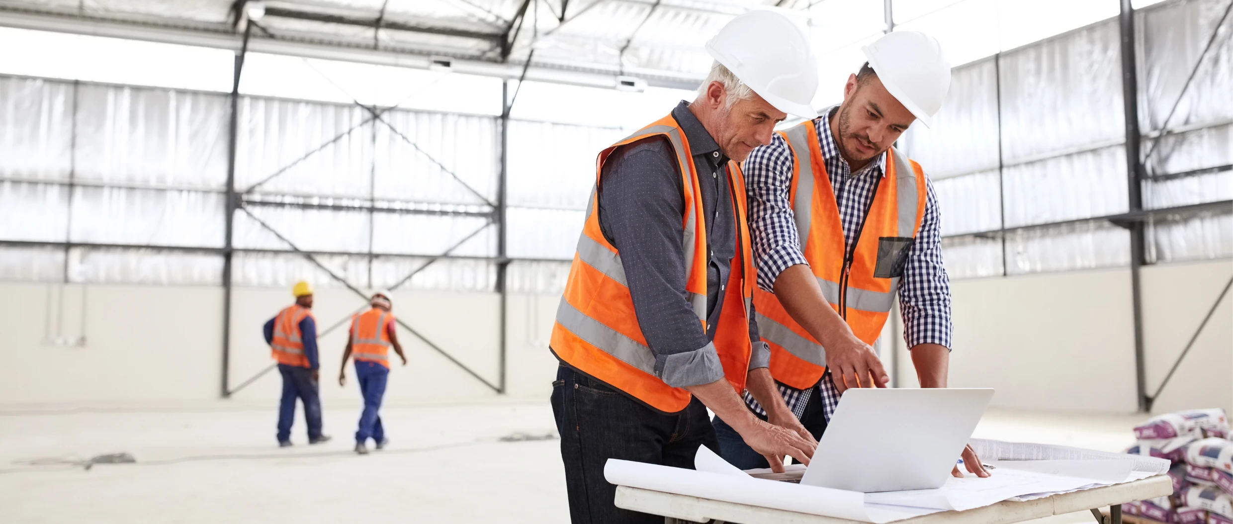 Engineers discussing project in warehouse